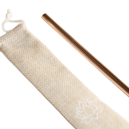 Close-up of rose gold metal straw partially inserted in beige drawstring storage pouch